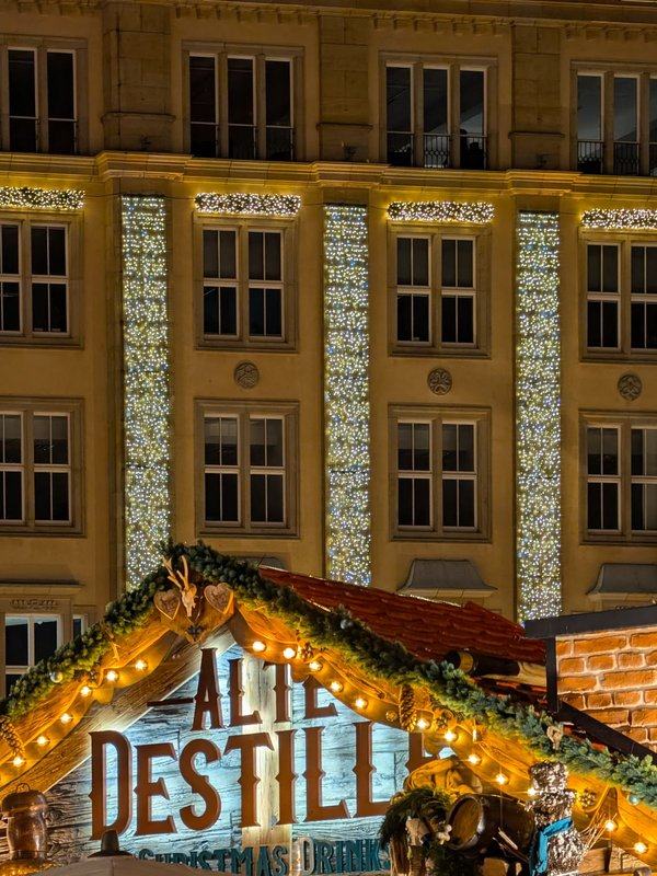 Festively lit Christmas market stall in Dresden in the evening